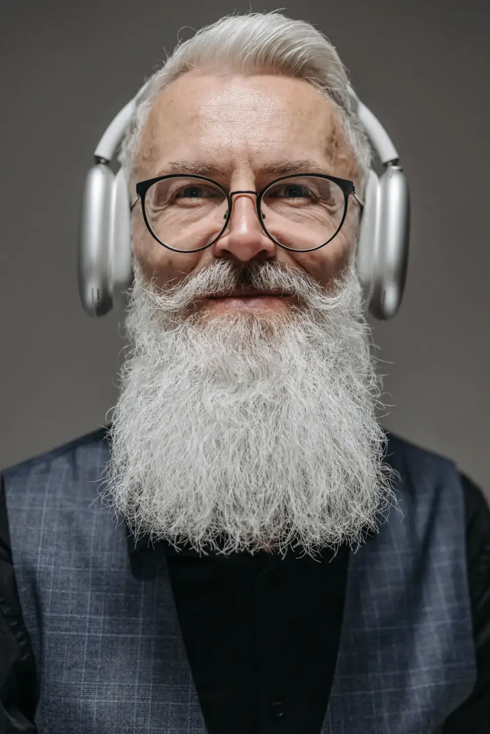 Older man wearing headphones and using sound therapy to help manage tinnitus and ear ringing