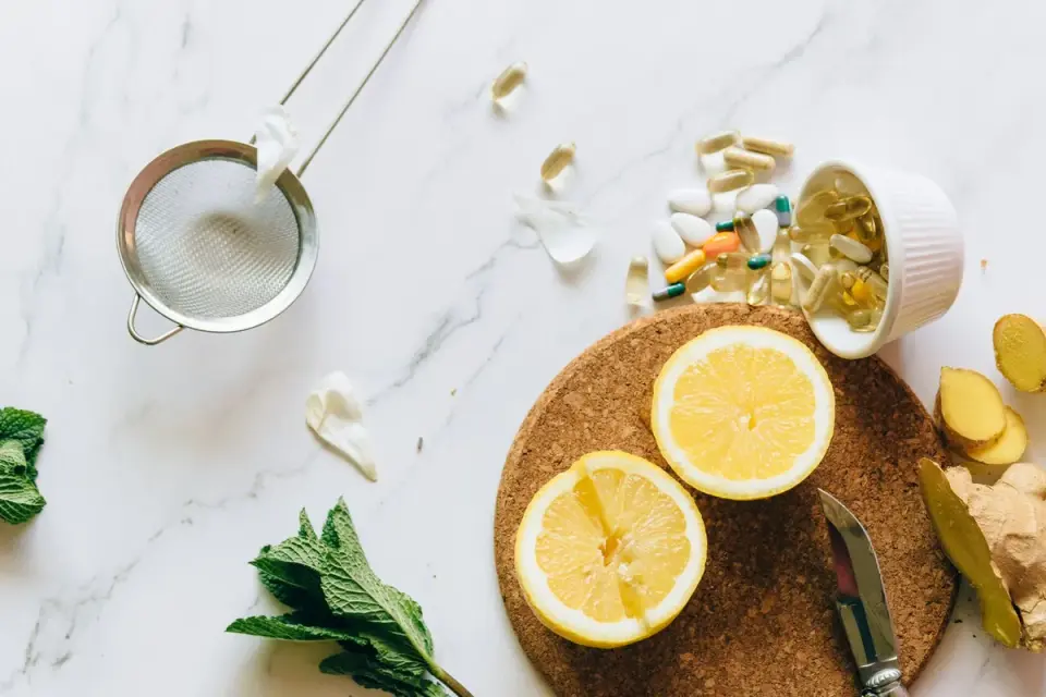Lemon ginger and natural supplements arranged on a wooden tray, representing nutrients for hearing health