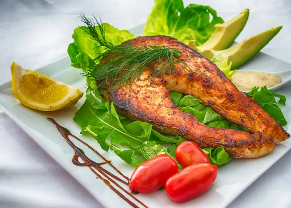 Grilled salmon fillet with vegetables, a top food source of omega-3 fatty acids for ear health